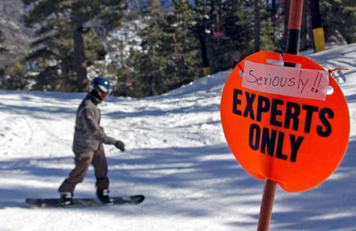 A sign warns skiers and snowboarders about the advanced runs heading down to the parking lot off of chair #1 at Mt. Waterman Ski Area in the Angeles National Forest