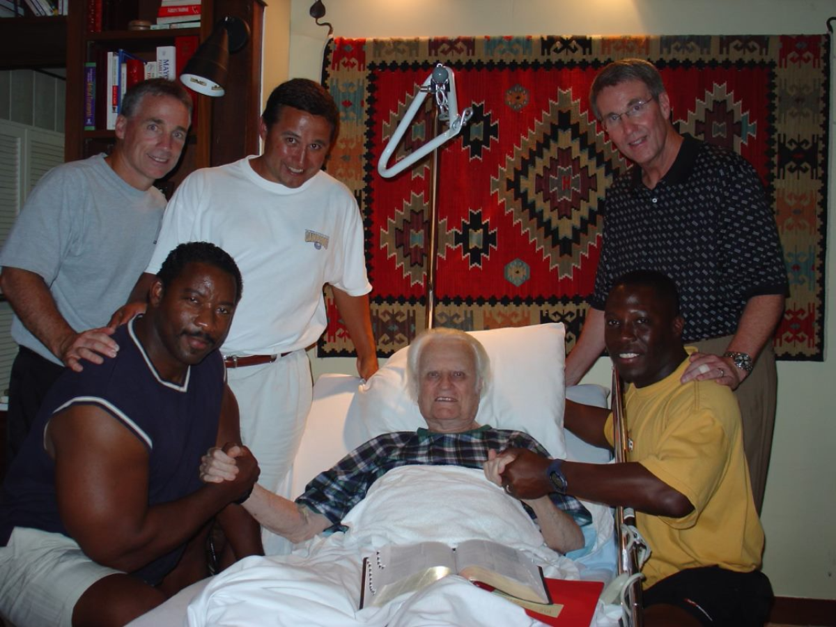 Clyde Christensen and others pose with the Rev. Billy Graham.