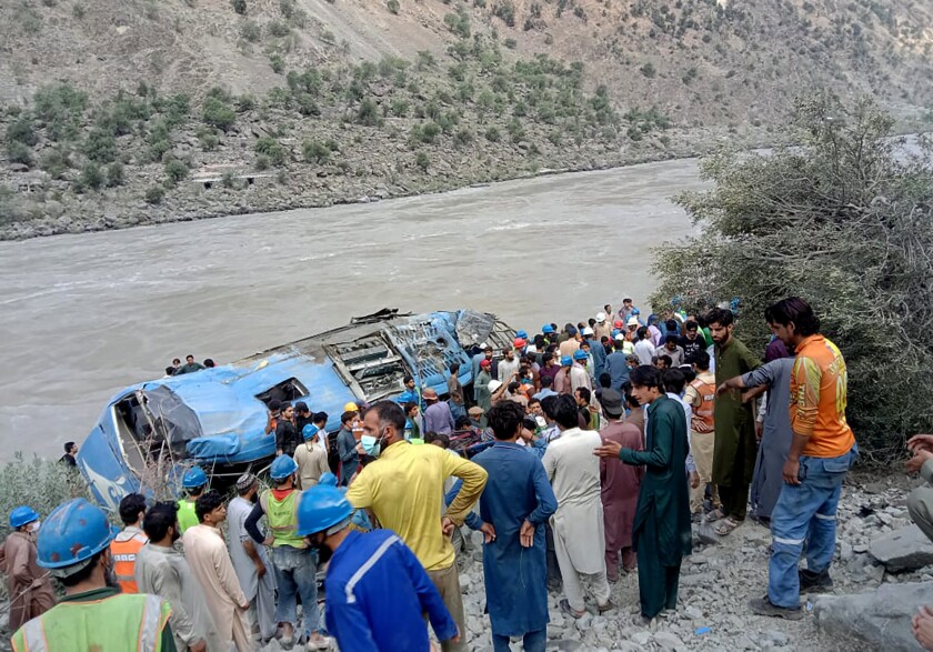 Local residents and rescue workers gather at the site of bus accident, in Kohistan Kohistan district of Pakistan's Khyber Pakhtunkhwa province, Wednesday, July 14, 2021. A bus carrying Chinese and Pakistani construction workers on a slippery mountainous road in northwest Pakistan fell into a ravine Wednesday, killing a dozen of people, including Chinese nationals, and dozens were injured, a government official said. (AP Photo)