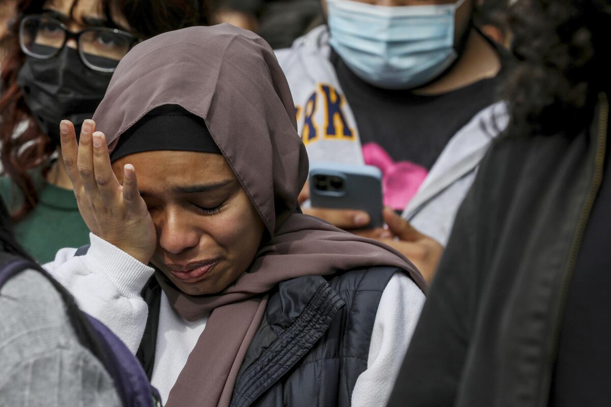A student cries while listening to the names of Palestinians killed during a rally in Berkeley calling for a cease-fire. 