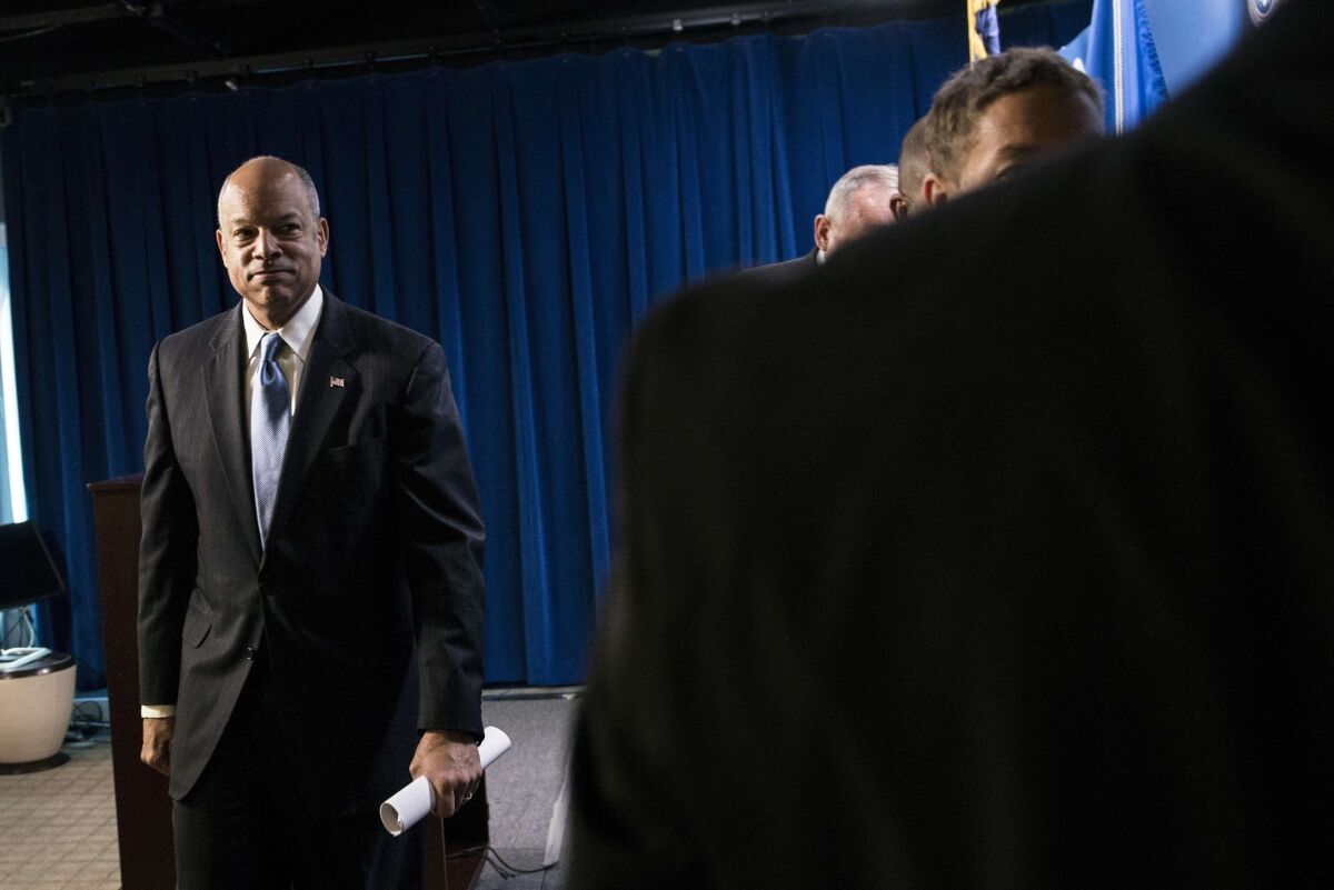 In Washington, Secretary of Homeland Security Jeh Johnson leaves a news conference after speaking about an investigation into a child pornography operation in which young boys were reportedly targeted online by men and tricked into creating sexually explicit videos of themselves.