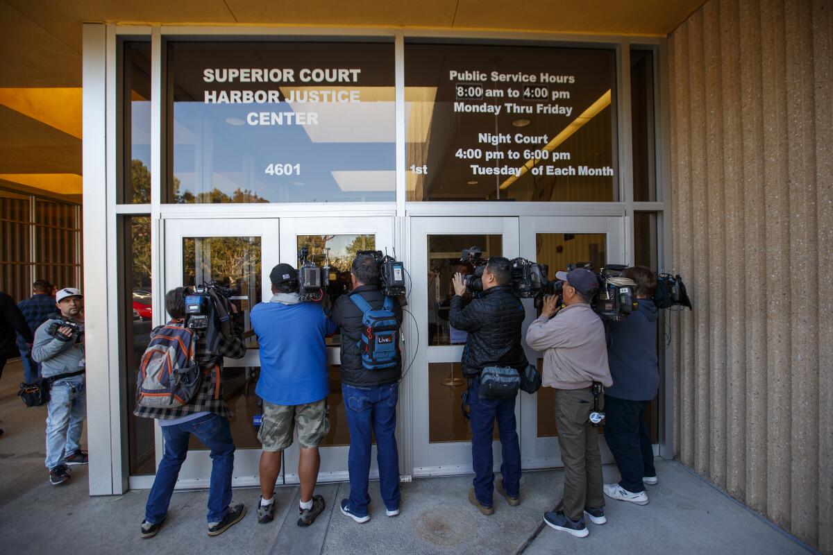 Media members in front of the Harbor Justice Center in Newport Beach on Feb. 7, 2020.
