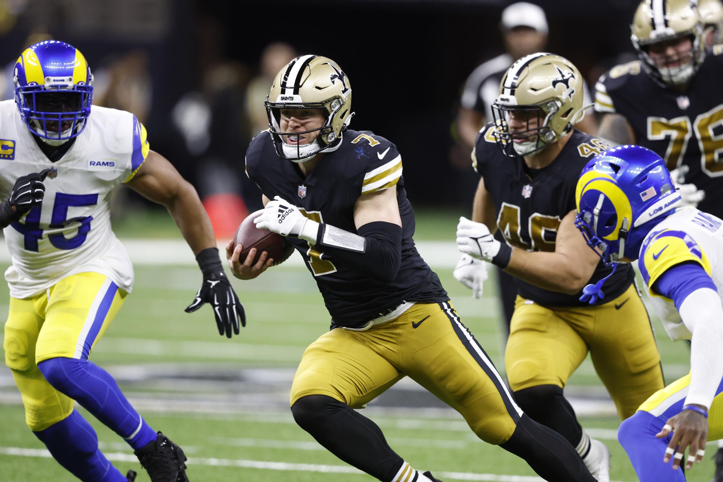 The Saints' Taysom Hill (7) runs the football against the Rams in 2022.