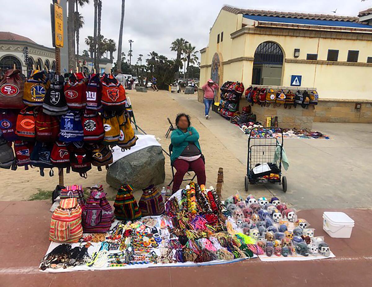 The City is working to create local regulations to incorporate a State law legalizing street vending that came into effect on Jan. 1. Last month, a resident sent this image to <i>PB Monthly</i> to illustrate his frustration with vendors crowding the pathways in Mission Beach.