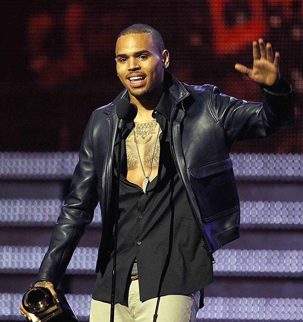 Chris Brown accepts a Grammy Award in 2012. The singer is fighting a city order to remove brightly colored murals outside his Hollywood Hills home.