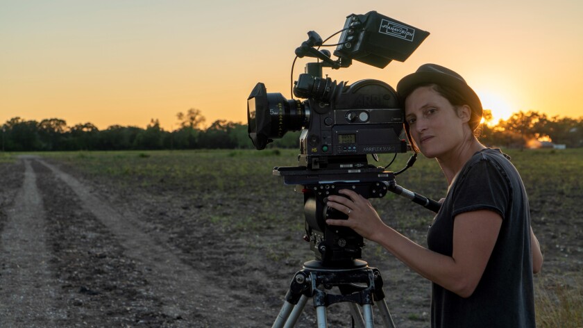 A photo of cinematographer Rachel Morrison looking through a camera. 