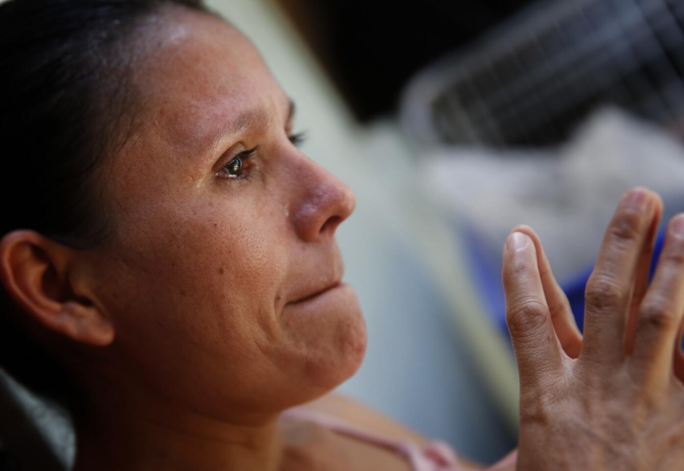 Just hours before departing San Pedro Sula, Honduras, Ana Marie Ramos, 35, cries as she talks about the gang slaying of her sister, the suicide of her brother and the passing of her elderly mother.