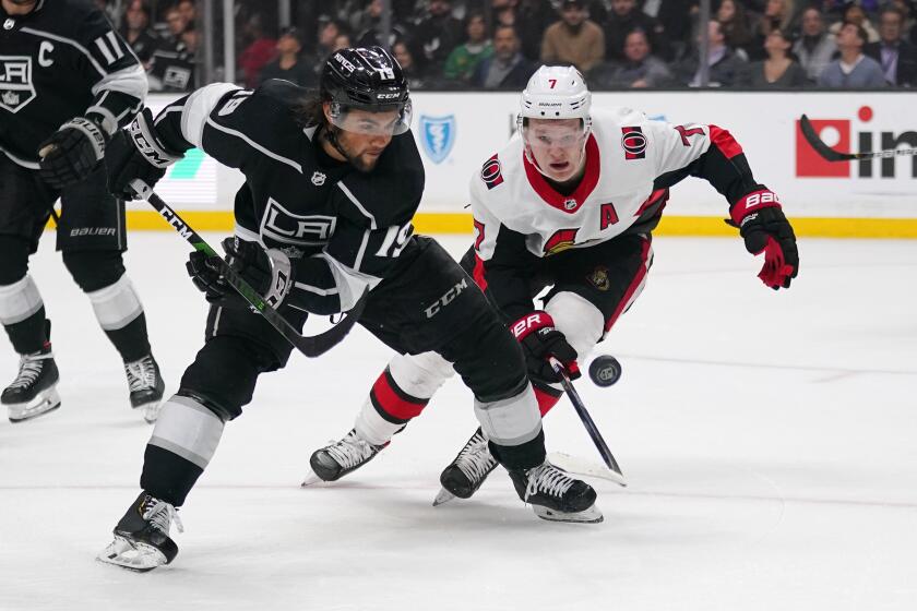 Los Angeles Kings left wing Alex Iafallo, left, goes after the puck along with Ottawa Senators left wing Brady Tkachuk during the third period of an NHL hockey game Wednesday, March 11, 2020, in Los Angeles. The Kings won 3-2. (AP Photo/Mark J. Terrill)