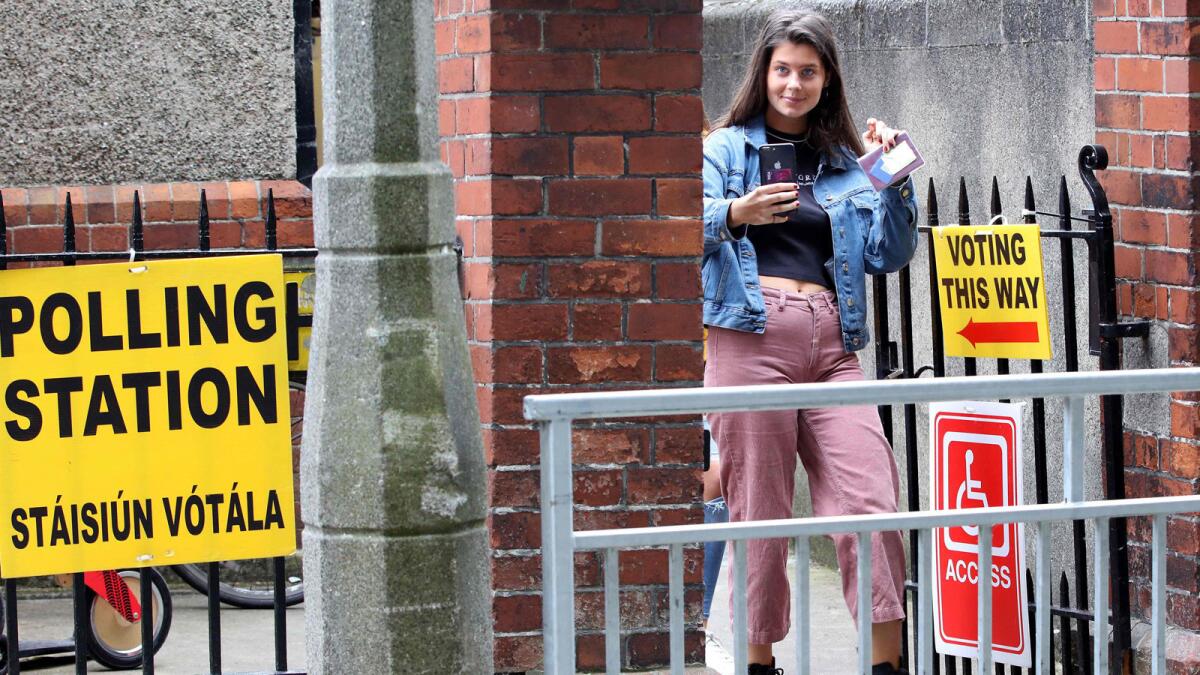 A Dublin voter leaves after casting her vote Saturday in the European elections, Ireland's local elections and the divorce referendum, all held concurrently.