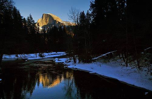 Yosemite National Park's Half Dome is reflected in the Merced River in this view from Sentinel Bridge. Members of the Civilian Conservation Corps replaced climbing cables on the mountain, among other projects in the park.