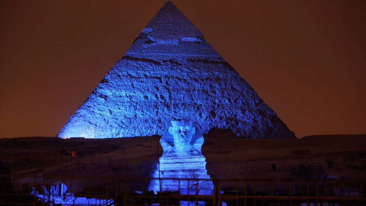 The Sphinx and the historical site of the Giza Pyramids are illuminated in 2015. A tourist bus was bombed Friday; nationalities of the tourists are not yet known.