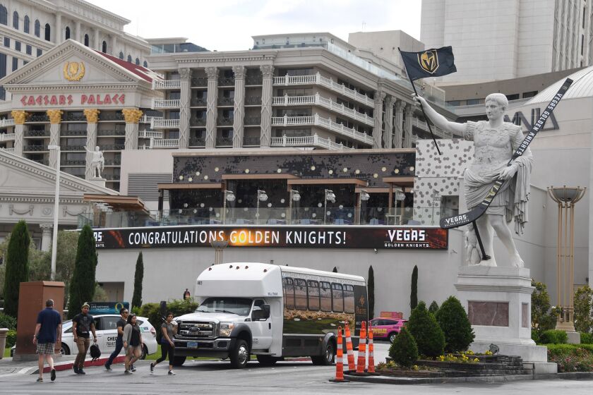 LAS VEGAS, NV - MAY 21: A statue of Julius Caesar in front of Caesars Palace displays an oversized Vegas Golden Knights hockey stick and a flag with the team logo as an electronic board displays a message of congratulations the day after the Golden Knights won the Western Conference Finals during the 2018 NHL Stanley Cup Playoffs on May 21, 2018 in Las Vegas, Nevada. Hotel-casinos along the Las Vegas Strip are showing their support for the hometown team after the Golden Knights beat the Winnipeg Jets four games to one to reach the Stanley Cup Finals on Sunday. (Photo by Ethan Miller/Getty Images) ** OUTS - ELSENT, FPG, CM - OUTS * NM, PH, VA if sourced by CT, LA or MoD **