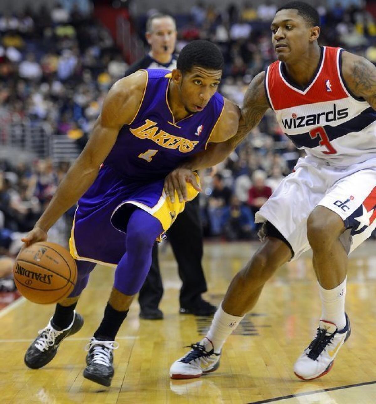 The Lakers' Darius Morris drives against Washington guard Bradley Beal in the first half on Dec. 14, 2012, at the Verizon Center.