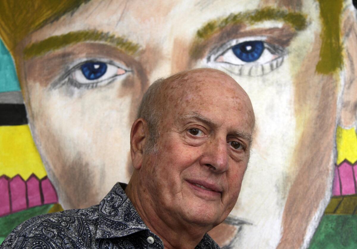 Mike Stoller, the veteran composer-producer who is married to Corky Hale, poses in front of an Elvis Presley painting by Frederick J. Brown at his office in West Hollywood in 2013.