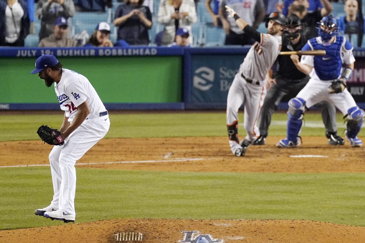 Dodgers relief pitcher Kenley Jansen celebrates along with catcher Will Smith after striking out Steven Duggar