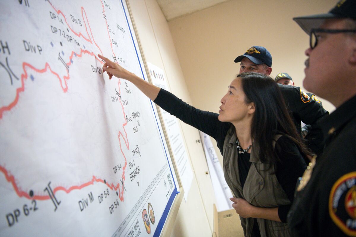 Sachi Hamai, Los Angeles County chief executive officer, reviews an operations map with fire commanders battling the devastating Woolsey fire in 2018. 
