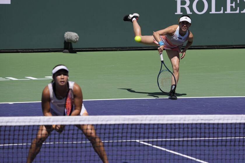 FILE - Miyu Kato, of Japan, right, serves behind her partner Aldila Sutjiadi, of Indonesia, as they play against Beatriz Haddad Maia, of Brazil, and Laura Siegemund, of Germany, in a doubles semifinal match at the BNP Paribas Open tennis tournament Friday, March 17, 2023, in Indian Wells, Calif. French Open doubles player Miyu Kato and her partner Aldila Sutjiadi have been forced to forfeit a match when Kato accidentally hit a ball girl in the neck with a ball after a point during their match against Marie Bouzkova and Sara Sorribes Tormo on Sunday, June 4, 2023. (AP Photo/Mark J. Terrill, File)