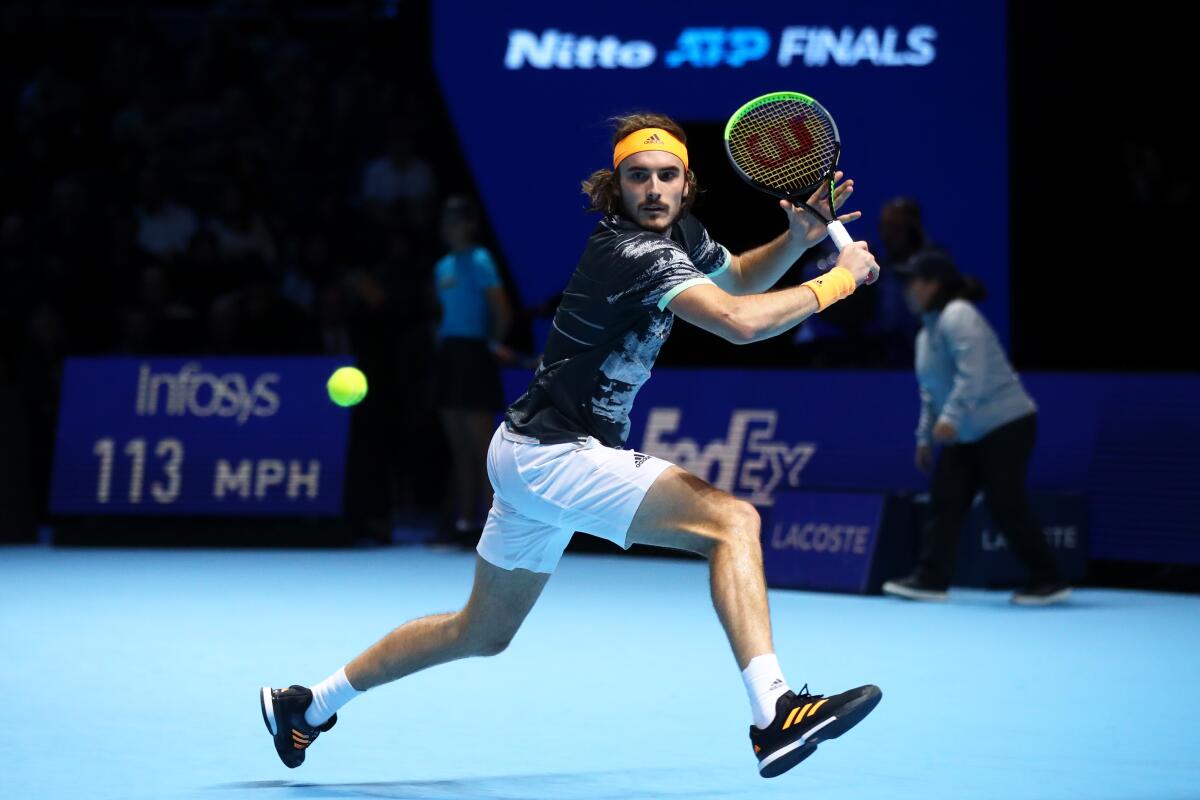 Stefanos Tsitsipas tries to track down a shot by Dominic Thiem during the ATF Finals championship match on Nov. 17, 2019, in London.