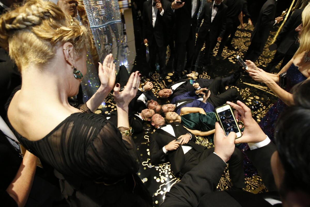 The cast of best picture winner "Spotlight" take a "floor selfie" backstage at the Oscars.