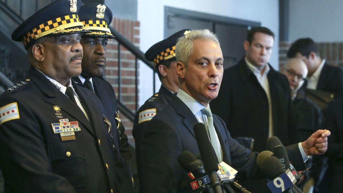 Chicago Mayor Rahm Emanuel, right, and Chicago Police Supt. Eddie T. Johnson, far left, appear at a news conference in Chicago on Tuesday.