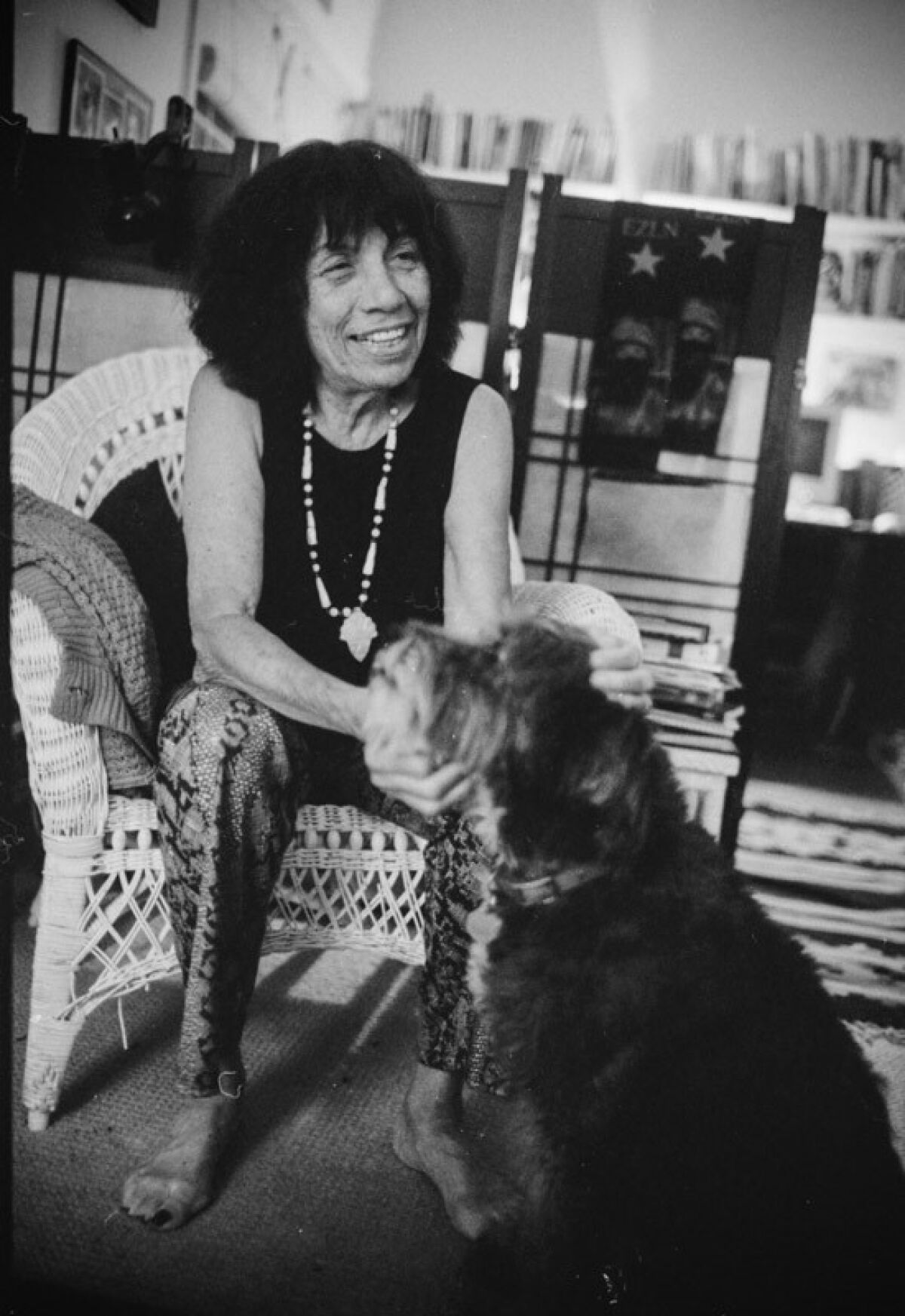 Elizabeth "Betita" Martínez pets her dog, Xochi, in her San Francisco home