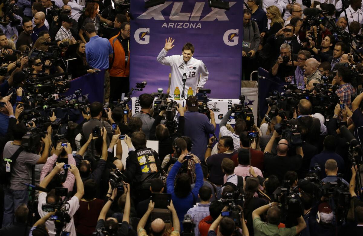 New England Patriots' Tom Brady waves during media day for Super Bowl XLIX in January.