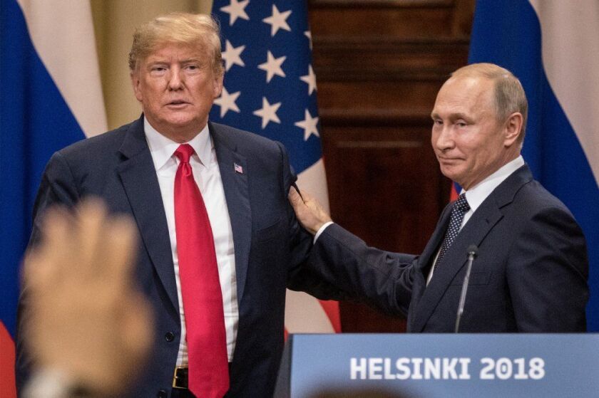 U.S. President Donald Trump and Russian President Vladimir Putin shake hands during a joint press conference after their summit on Monday in Helsinki, Finland.