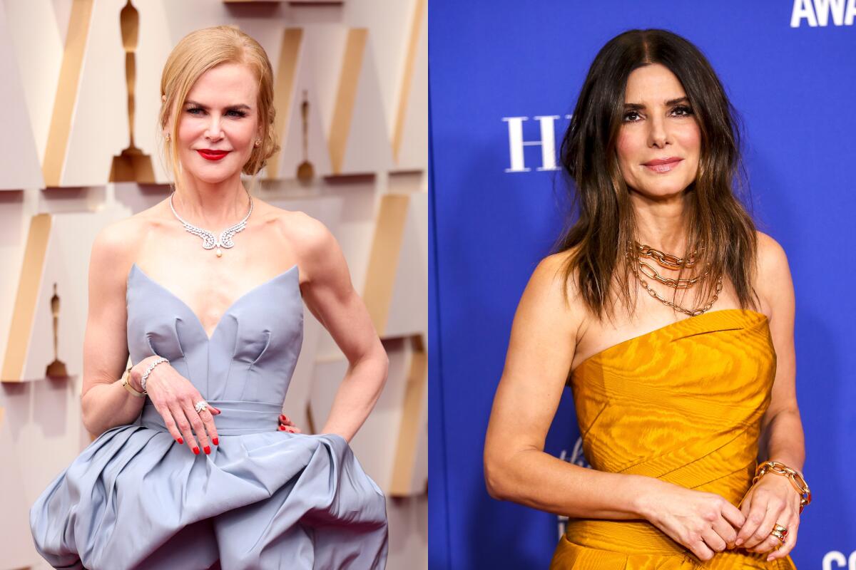 Nicole Kidman wearing a pale blue strapless gown and Sandra Bullock wearing a strapless orange gown