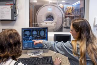 Michael Yassa group demonstrating MRI brain scan technology in FIBRE lab.
