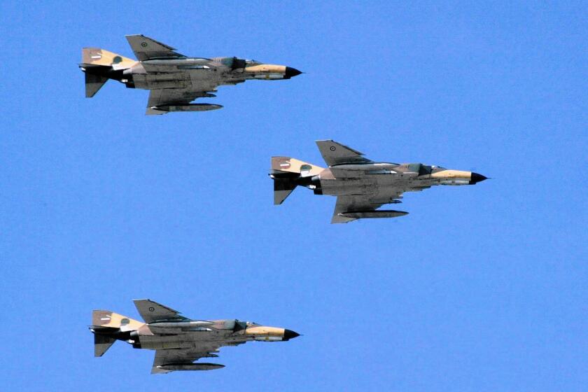 F-4 Phantom jets take part in a flyover in Tehran, which recently deployed similar jets in airstrikes against Islamic State militants in Iraq.