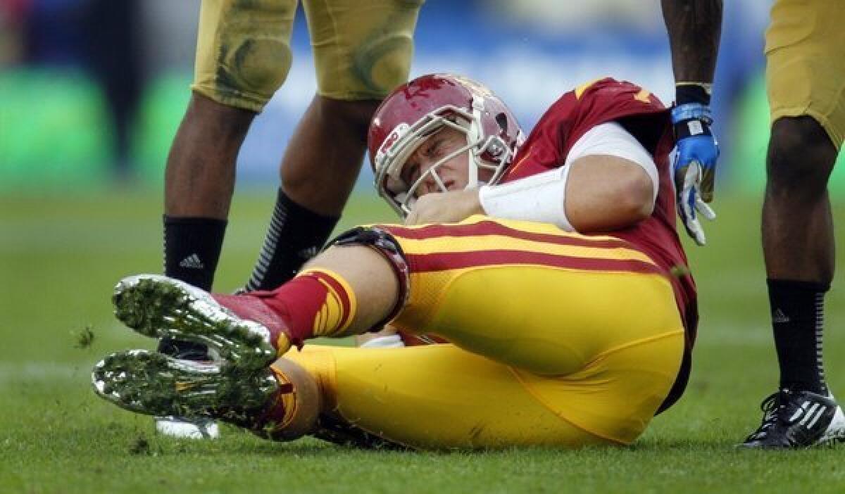 Matt Barkley winces in pain after being sacked during USC's loss to UCLA.