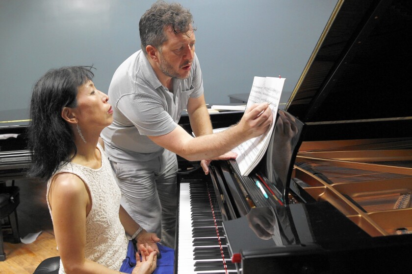 Composer-musician Thomas Adès practices for a Pianosphere performance with pianist Gloria Cheng at Steinway in Los Angeles on Aug. 28, 2015.