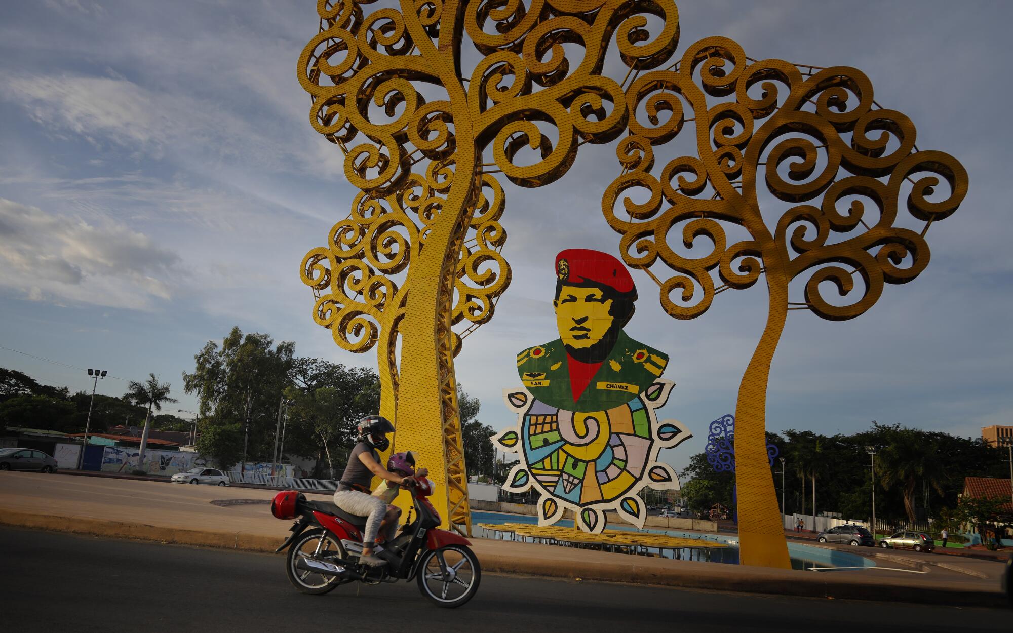 Part of the Trees of Life art installation surrounds a tribute to Hugo Chávez in a traffic circle in Managua