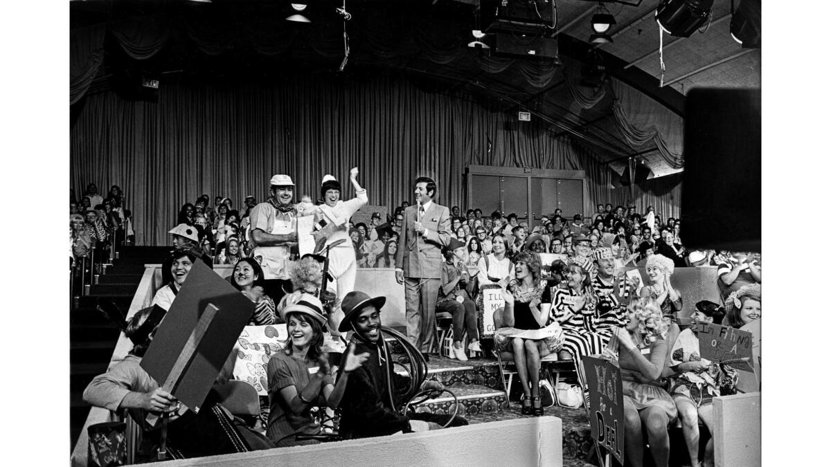 Aug. 1, 1973: Host Monte Hall, standing right, with two contestants dressed as painters, during taping of the television show "Let's Make a Deal." This photo appeared in the Sept. 9, 1973, Los Angeles Times.