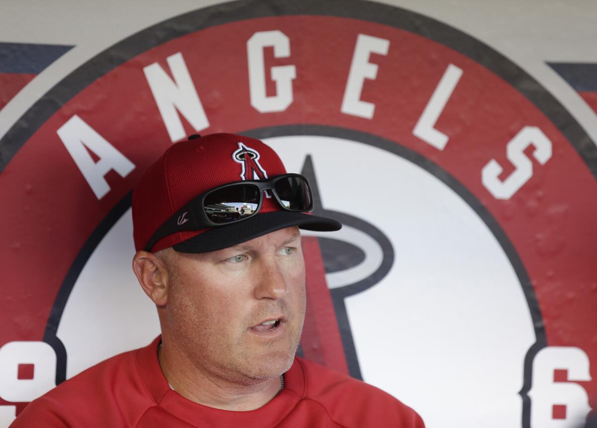 Mike Butcher sits in the Angels dugout before a game against the Oakland Athletics on April 10, 2013.
