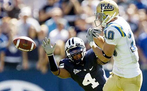 Brigham Young's Brandon Howard tries to disrupt a pass to UCLA receiver Gavin Ketchum during the first quarter Saturday.