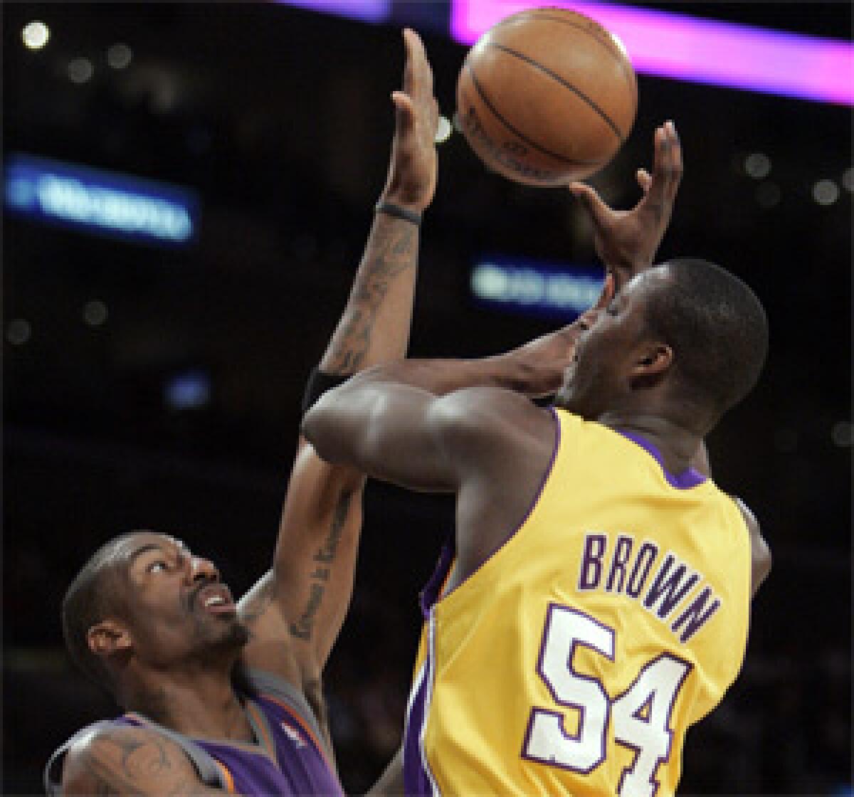 AFFECTED: Kwame Brown, whose shot is blocked by Phoenix's Amare Stoudemire, says he went "into a shell" after hearing boos from Lakers fans during his seven-turnover game against the Suns on Thursday.