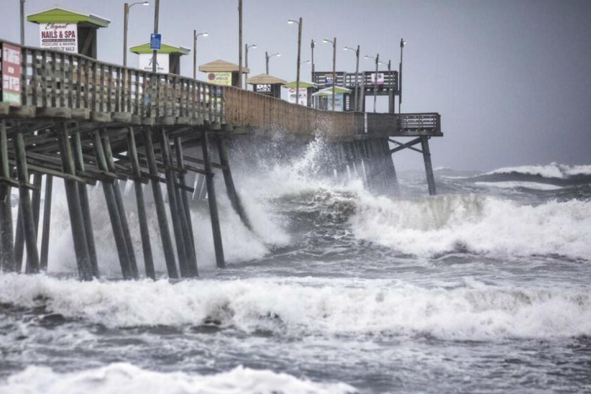 Waves pound the Bogue Inlet Fishing Pier in Emerald Isle, N.C., on Thursday.