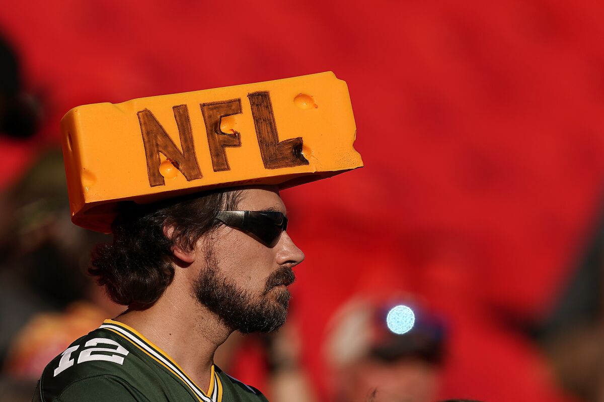 A fan watches warmups before a preseason NFL football game between the Green Bay Packers and the Kansas City Chiefs Thursday, Aug. 25, 2022, in Kansas City, Mo. (AP Photo/Charlie Riedel)
