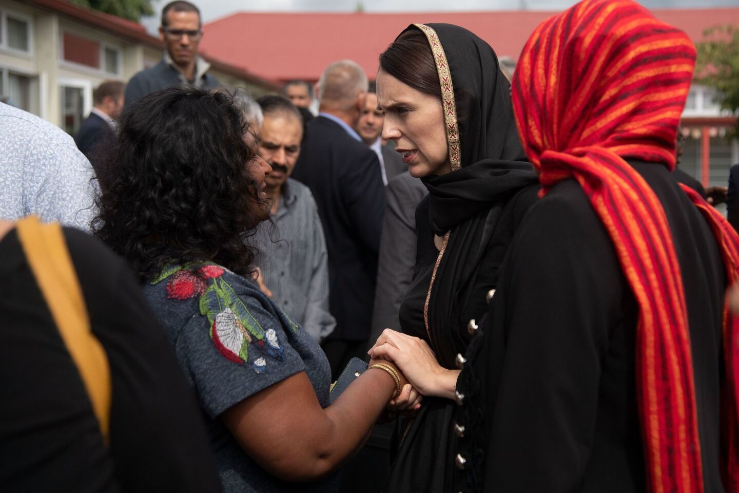 New Zealand Prime Minister Jacinda Ardern, right, speaks with a representative of the Canterbury Refugee Center in Christchurch.
