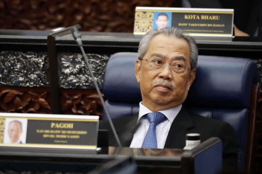 FILE - In this July 13, 2020, file photo, Malaysian Prime Minister Muhyiddin Yassin attends a Parliament session at lower house in Kuala Lumpur, Malaysia. Malaysia's government announced Monday, July 5, 2021 that Parliament will resume July 26, caving into pressure from the king to lift the legislature's suspension under a coronavirus emergency imposed in January. (AP Photo/Vincent Thian, File)