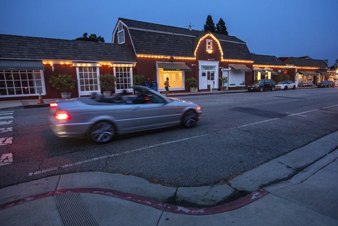 A jogger makes his way past the Brentwood Country Mart.