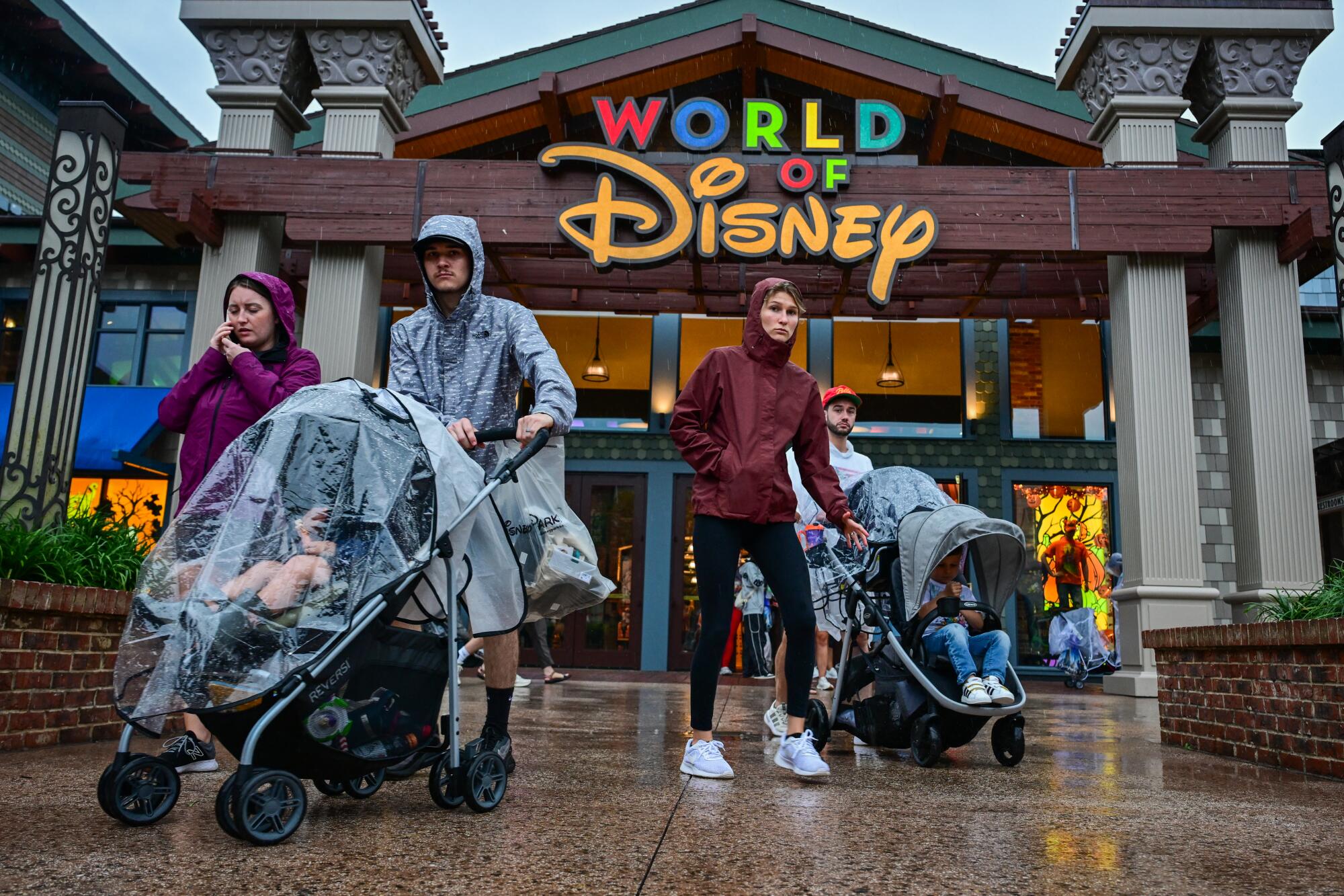 Visitors walk through the Disney Springs shopping center.