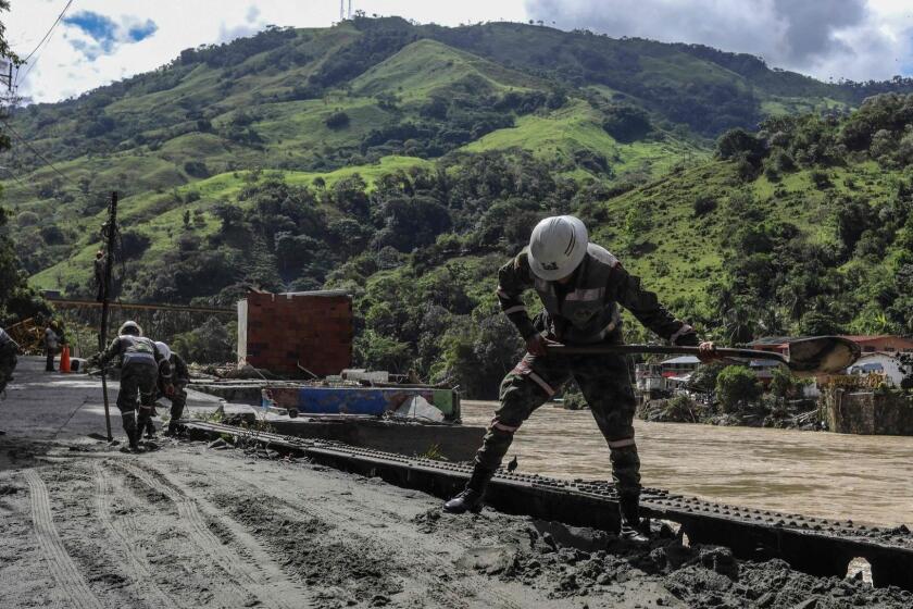 Soldiers remove mud from the streets of Puerto Valdivia municipality two days after a landslide that blocked the diversion tunnel of the Cauca river at the construction site of the Ituango dam caused the overflooding of the river, in Antioquia Department, Colombia, on May 14, 2018. The work that should be the pride of a nation is beginning to make water. An apparent geological fault at the construction site of the largest hydroelectric project in Colombia, which plans to cover almost a fifth of the country's energy demand, has more than 130,000 people on alert. / AFP PHOTO / Joaquin SARMIENTOJOAQUIN SARMIENTO/AFP/Getty Images ** OUTS - ELSENT, FPG, CM - OUTS * NM, PH, VA if sourced by CT, LA or MoD **