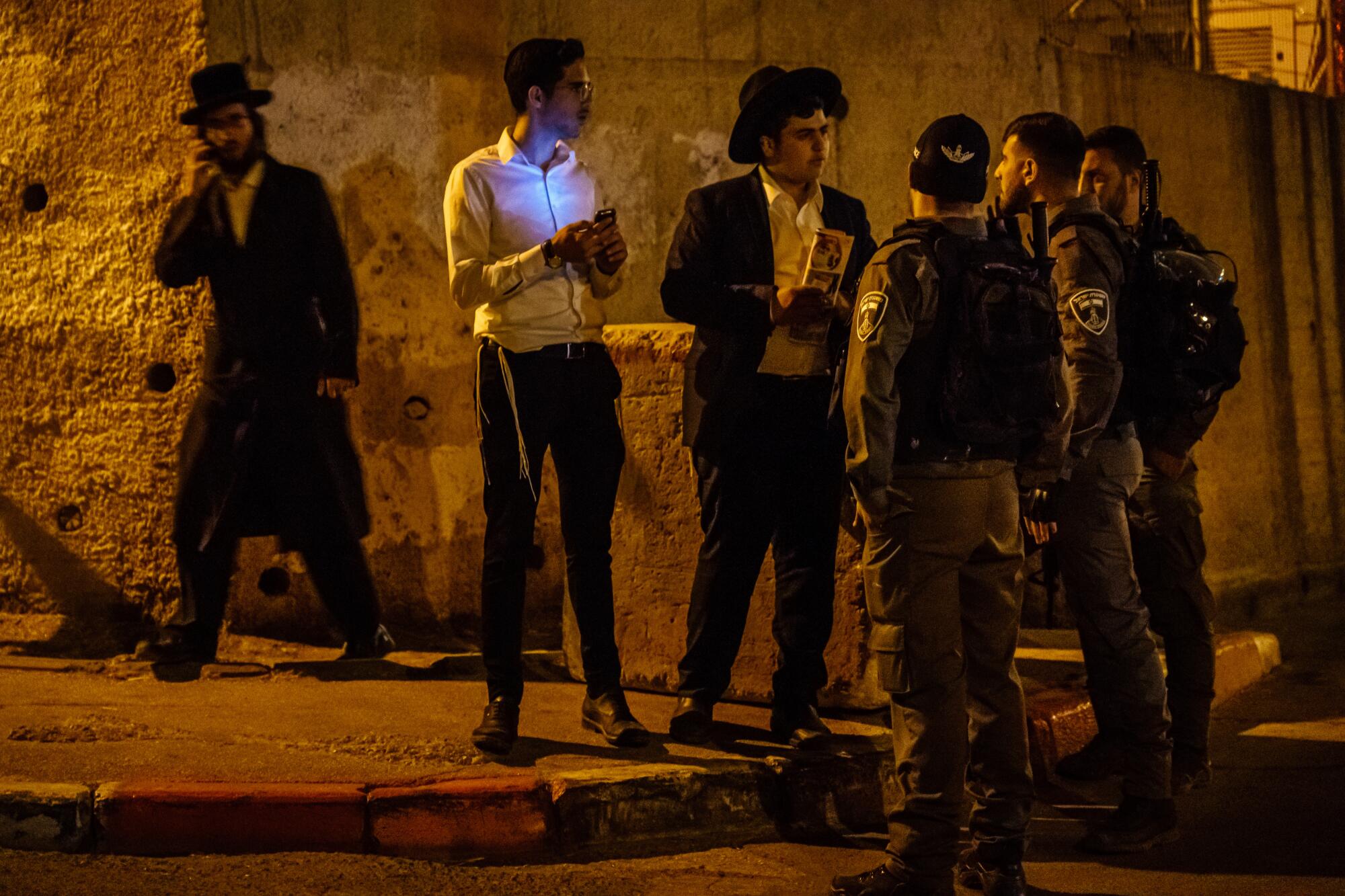 Israeli security officers escort nonresidents out of the Sheikh Jarrah neighborhood of East Jerusalem