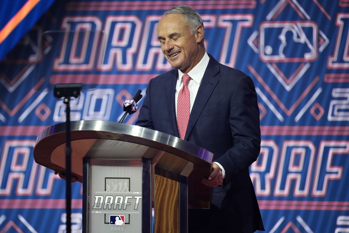 MLB Commissioner Rob Manfred reacts as he is booed by fans during the first round of the 2021 MLB baseball draft, Sunday, July 11, 2021, in Denver. (AP Photo/David Zalubowski)
