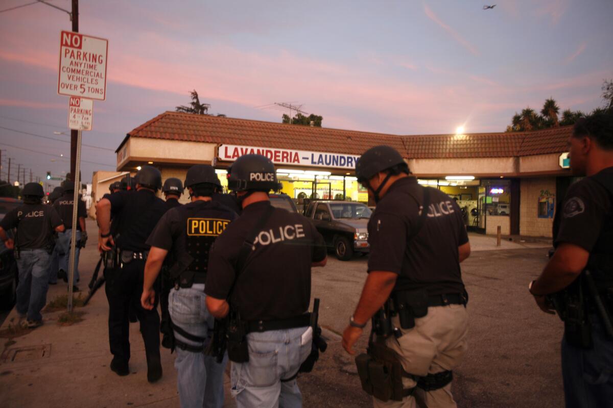Officers ready themselves for a 2009 raid against suspected Florencia 13 gang members near South Los Angeles.