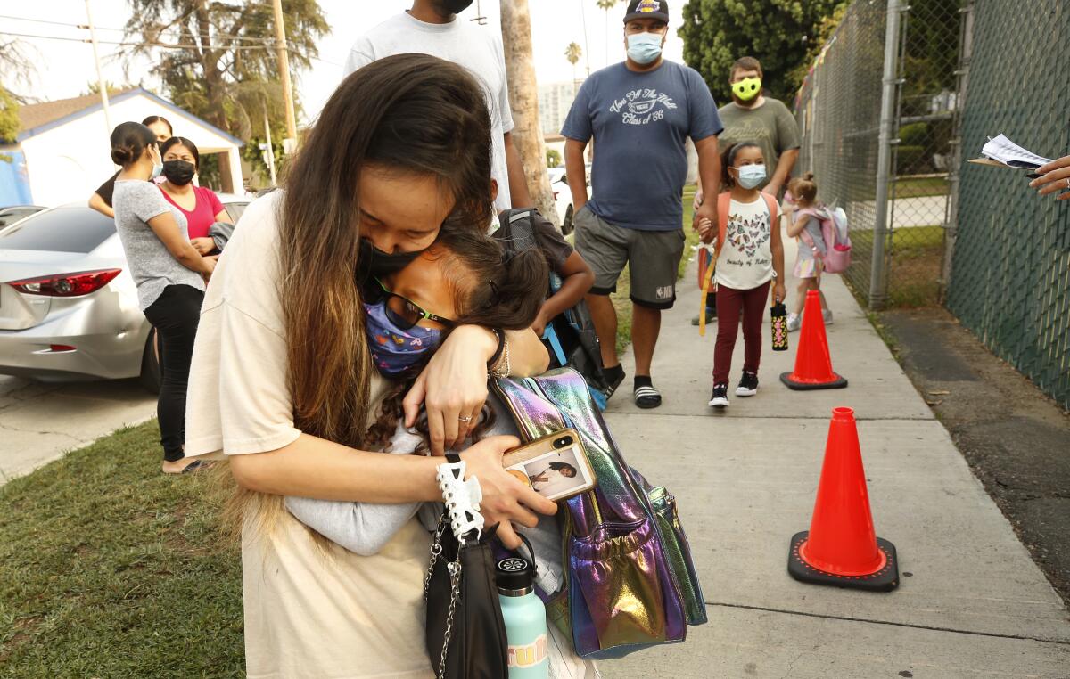 Kindergartner Rylee Doan gets in a last hug with her mother Tiffany Doan-Evans.