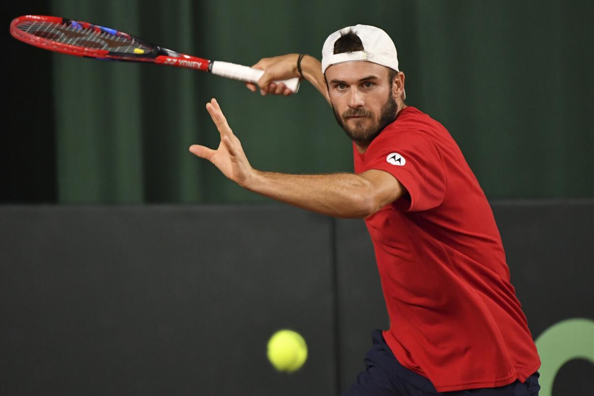 Tommy Paul of the USA returns the ball to Khumoyun Sultanov of Uzbekistan during a singles Davis Cup qualifier tennis match between Uzbekistan and the USA in Tashkent, Uzbekistan, Friday, Feb. 3, 2023. (AP Photo)