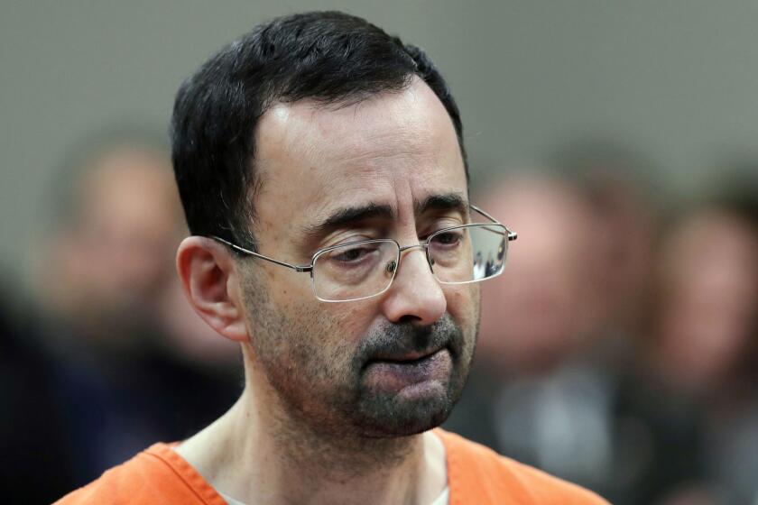 FILE - In this Nov. 22, 2017 file photo, Dr. Larry Nassar, 54, appears in court for a plea hearing in Lansing, Mich. Michigan State University announced Wednesday, May 16, 2018, that it has reached a $500 million settlement with hundreds of women and girls who say they were sexually assaulted by sports Nassar in the worst sex-abuse case in sports history. (AP Photo/Paul Sancya, File)